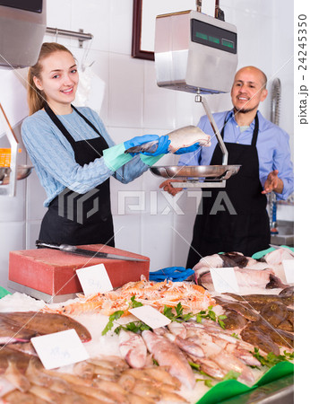 Two sellers in fish store . 24245350