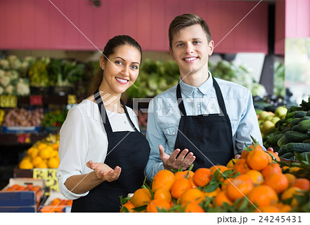 Supermarket workers selling oranges Supermarket workers selling oranges 24245431