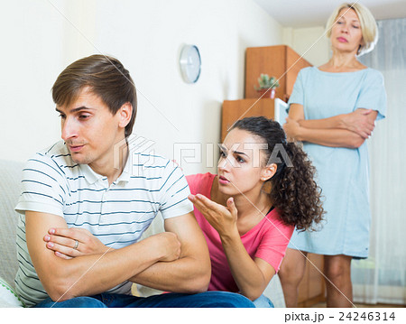 Adult man listening reproaches from girlfriend and her mother 24246314