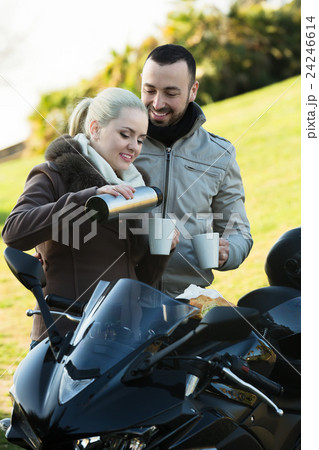 Couple posing near motor bike Couple posing near motor bike 24246614