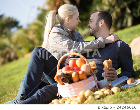 Couple lounging at picnic outdoors 24246616