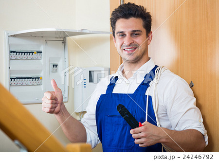 Electrician fixing problems of automatic electric meter 24246792