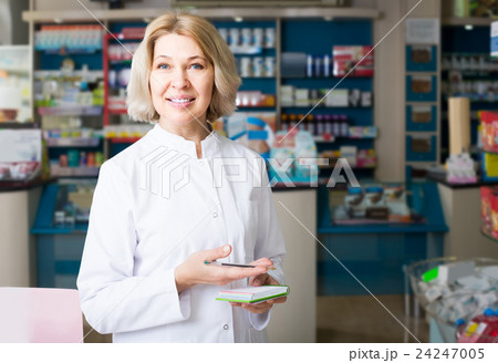 female pharmacist posing in drugstore female pharmacist posing in drugstore 24247005