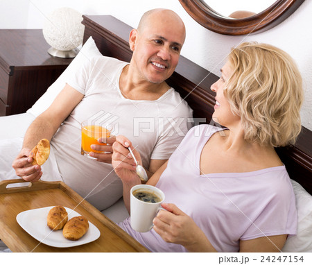Couple having breakfast in bed Couple having breakfast in bed 24247154
