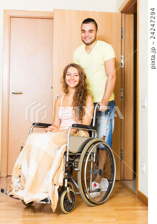 Worker brought person in wheelchair 24247294