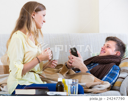 Wife taking care of husband with flue. Wife taking care of husband with flue. 24247790