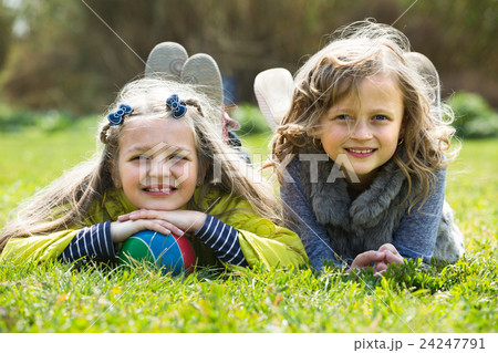 girls relaxing in grass girls relaxing in grass 24247791