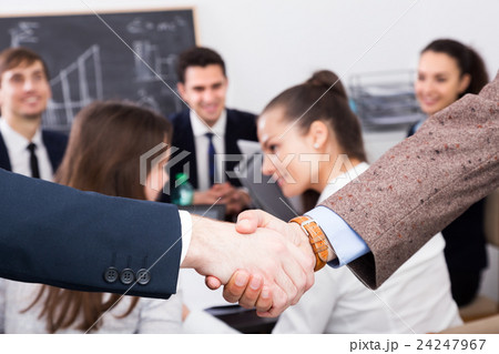 Two managers shaking hands Two managers shaking hands 24247967