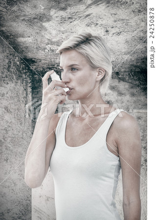 Composite image of blonde woman taking her inhaler Composite image of blonde woman taking her inhaler 24250878