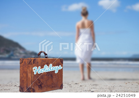 Composite image of blonde in white dress walking on the beach 24251049