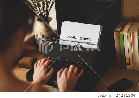 Breaking news against young woman using typewriter 24251504
