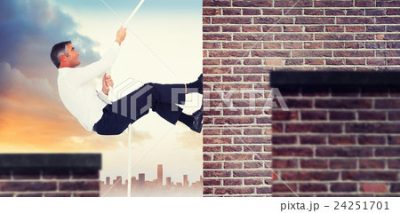 Composite image of businessman pulling rope while sitting on cube Composite image of businessman pulling rope while sitting on cube 24251701