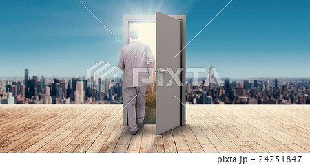 Composite image of young businessman walking away from camera 24251847