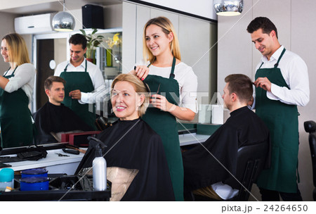 Positive young woman cutting female pensioner hair Positive young woman cutting female pensioner hair 24264650