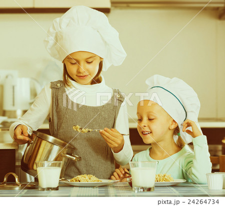 girls having breakfast with porridge girls having breakfast with porridge 24264734