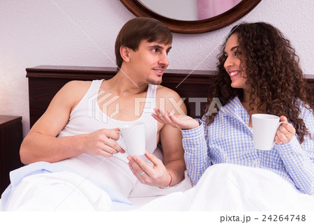 Couple drinking coffee in the bed. 24264748