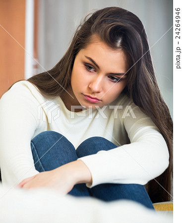 Portrait of sad young brunette at home 24264946