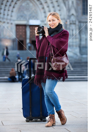 Young woman looking and taking pictures outdoors 24265467