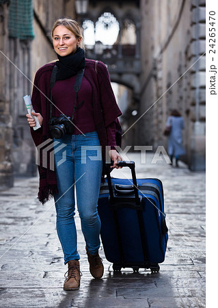 Tourist girl walking with the travel bag. 24265470