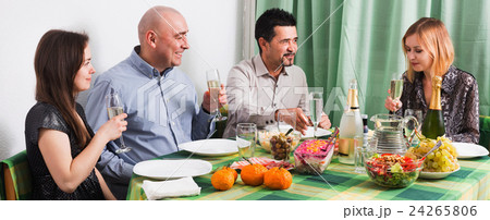 Group of friends eating at festive table 24265806