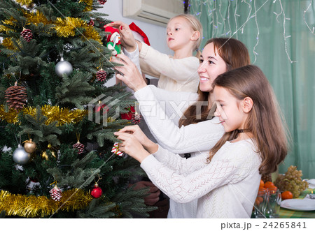 Family decorating Christmas tree at home Family decorating Christmas tree at home 24265841