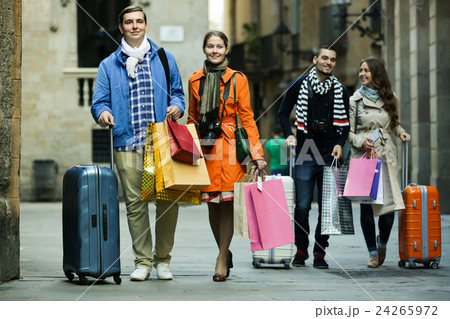 Tourists walking with shopping bags . Tourists walking with shopping bags . 24265972