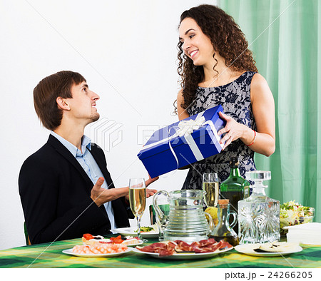 Man giving present to woman Man giving present to woman 24266205