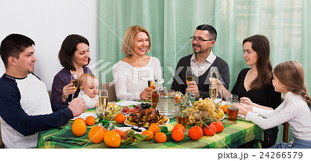 Multigenerational big family sitting at holiday table Multigenerational big family sitting at holiday table 24266579