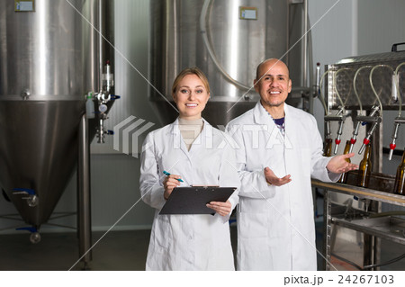 Man and woman working on brewery. Man and woman working on brewery. 24267103