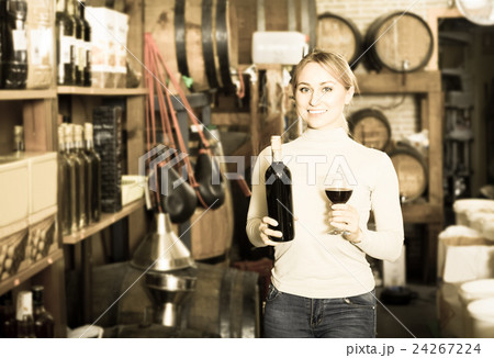 woman holding bottle of wine woman holding bottle of wine 24267224