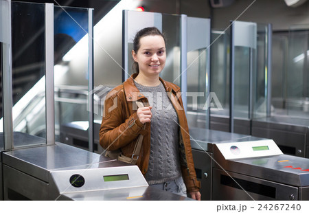 Girl passing ticket barrier in subway . 24267240