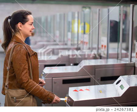 Girl passing ticket barrier in subway . Girl passing ticket barrier in subway . 24267381