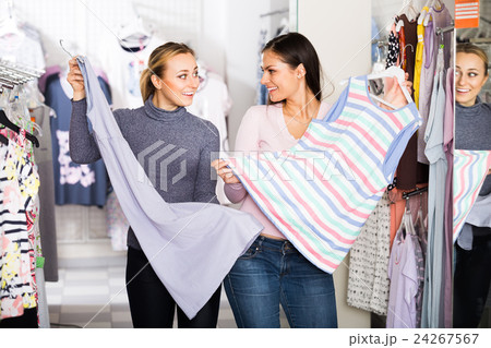Two women selecting sleepwear in store. 24267567