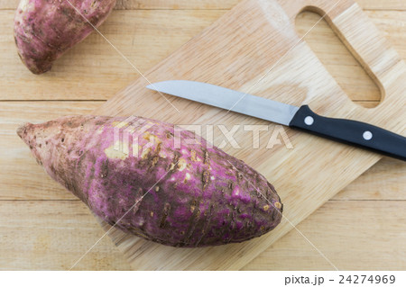 Sweet potato on wooden cutting board. 24274969