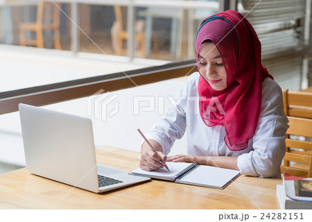 Muslim woman working with computer. Muslim woman working with computer. 24282151