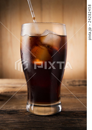 Cold fizzy cola soda with ice in glass cup Cold fizzy cola soda with ice in glass cup 24282458
