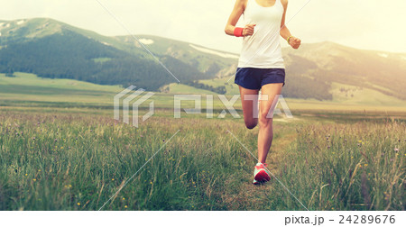 young fitness woman runner running on grassland 24289676