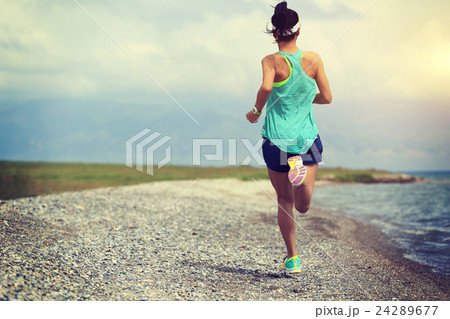 young woman trail runner running on seaside 24289677