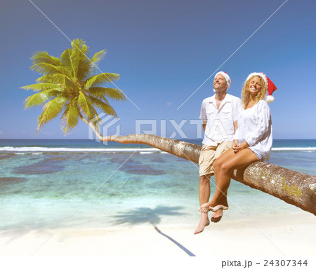 Couple Relaxing on the Beach Concept Couple Relaxing on the Beach Concept 24307344