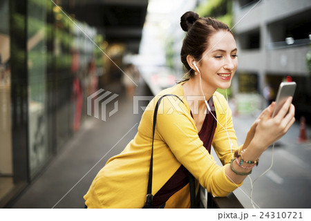 Woman Listening Music Media Entertainment Traveling Concept Woman Listening Music Media Entertainment Traveling Concept 24310721