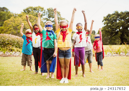 Group of children with superhero dress posing with raised arms 24317652