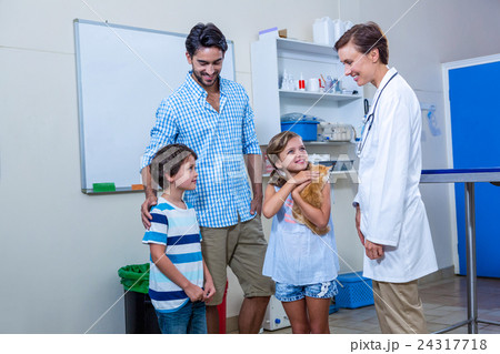 Family smiling with their woman vet 24317718