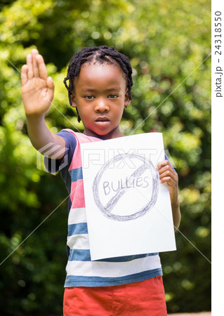 Boy saying stop with hand and paper 24318550