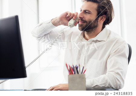 Businessman passing a call Businessman passing a call 24318835