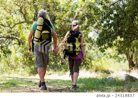 Couple hiking and holding hands each other Couple hiking and holding hands each other 24318837
