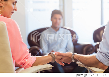 Psychologist helping a couple with relationship difficulties Psychologist helping a couple with relationship difficulties 24318853