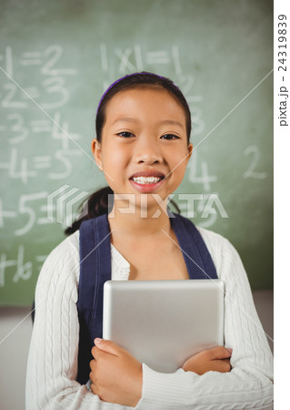 Cute schoolgirl smiling at camera Cute schoolgirl smiling at camera 24319839
