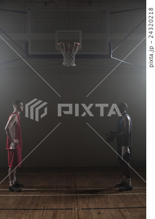 Two basketball rival looking each other face to face Two basketball rival looking each other face to face 24320218