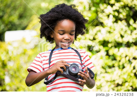 Boy looking at his camera Boy looking at his camera 24320238