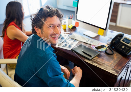 Colleagues using technology Colleagues using technology 24320429